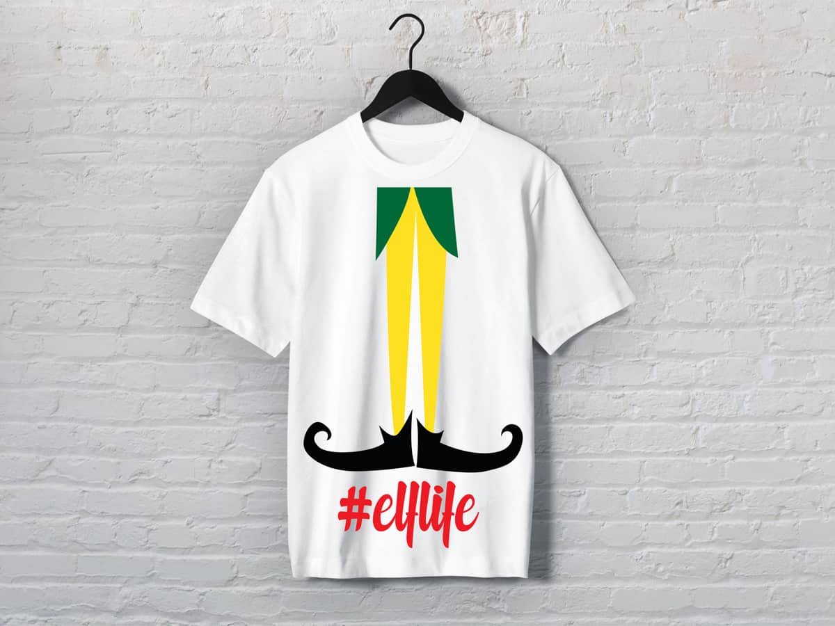 A t-shirt with an illustration of Elf legs and the hashtag #Elflife against a white wall
