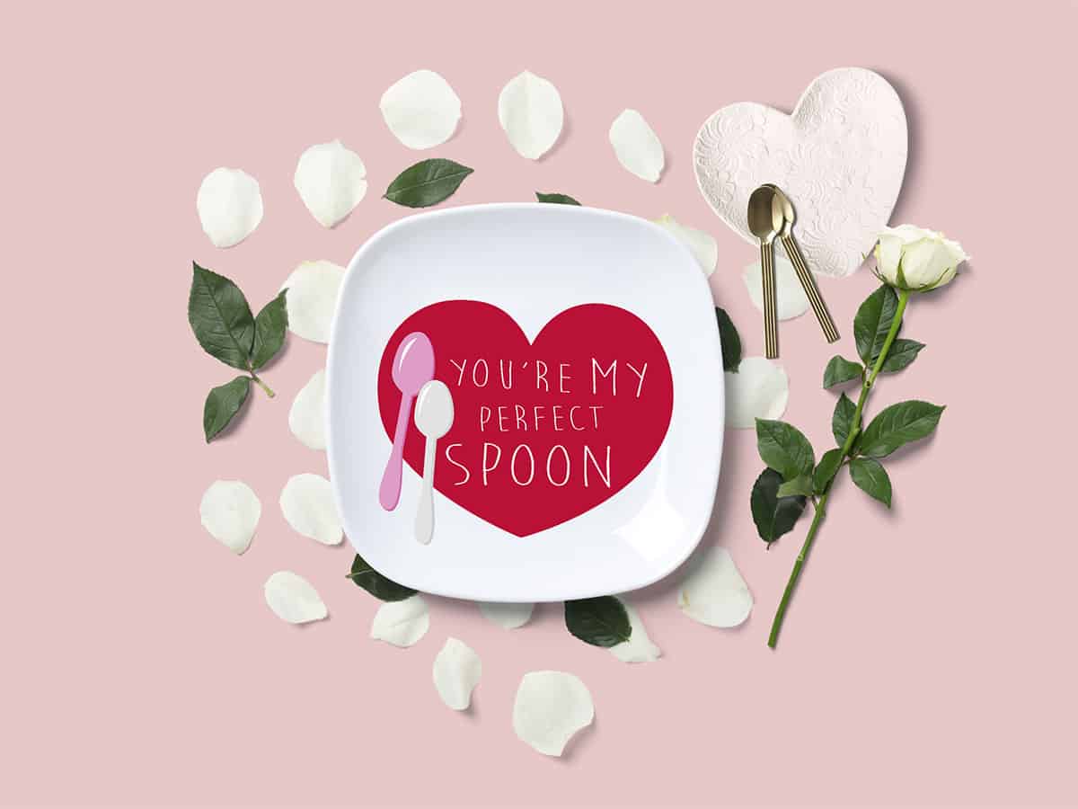 Plate with an illustration of a heart with two spoons and the text "You're my perfect spoon" on a light pink background.