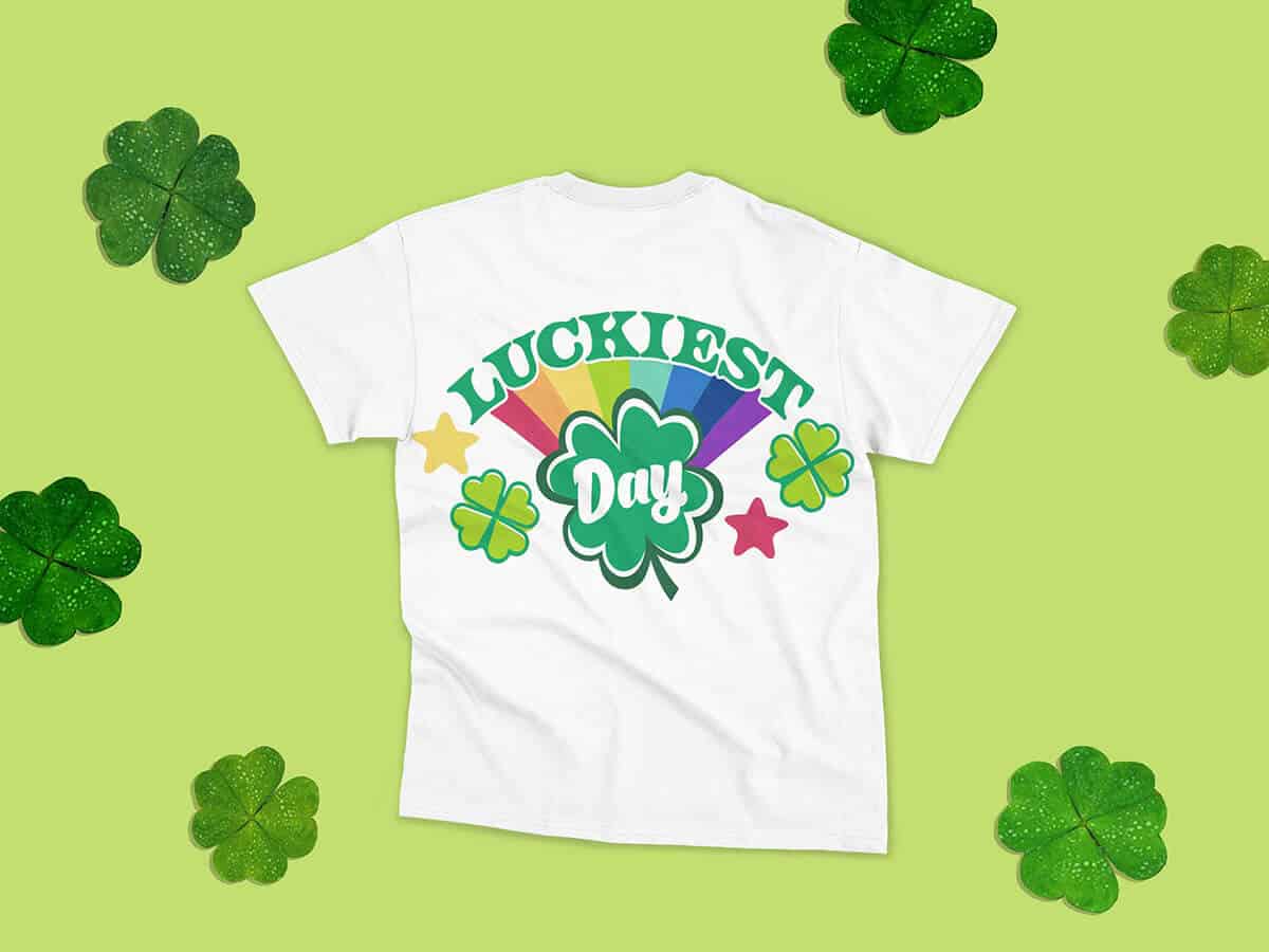 T-shirt in white with an illustration of shamrocks and the phrase "Luckiest Day"