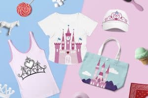 Children's apparel and accessories with a castle and crown theme displayed on a split pink and blue background.