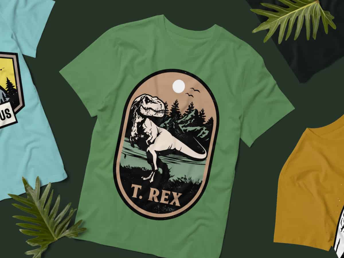 Green T-shirt with a T. rex print in a vintage badge design.