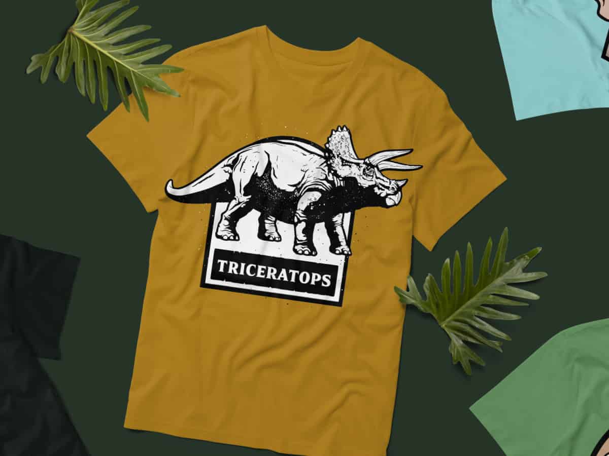 Mustard yellow T-shirt featuring a Triceratops silhouette graphic.