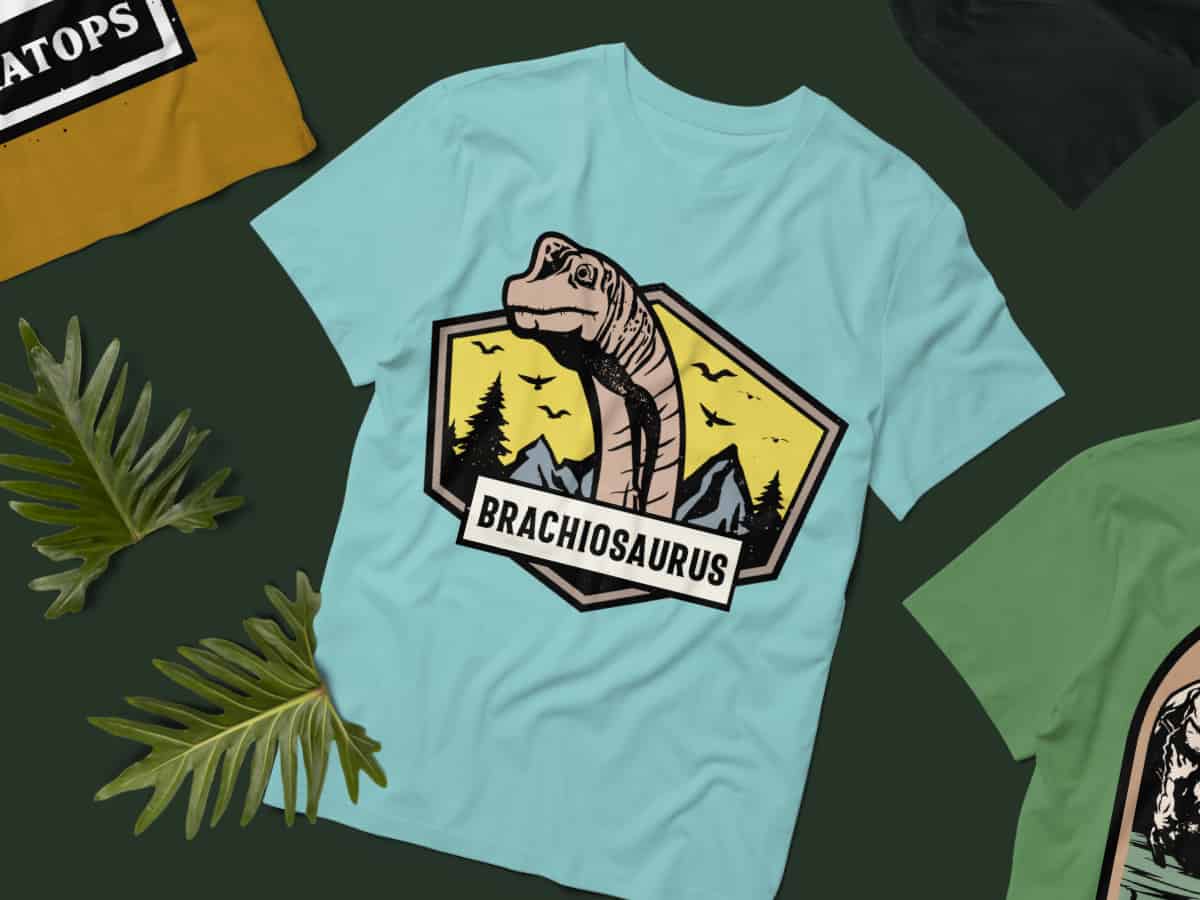 Light blue T-shirt with a Brachiosaurus graphic in a hexagonal frame.