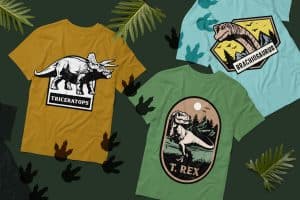 Assortment of dinosaur-themed T-shirts in various colors and designs.